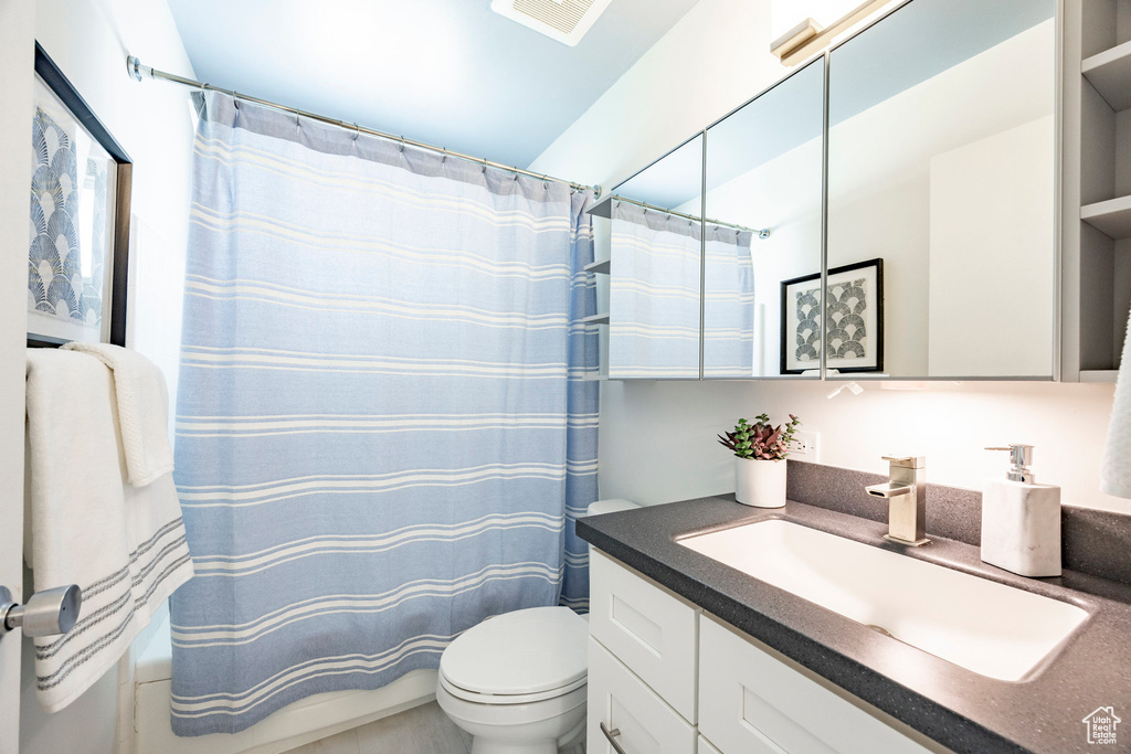 Bathroom with visible vents, toilet, and vanity