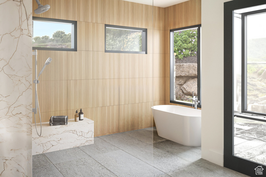 Full bathroom featuring a marble finish shower and a freestanding tub