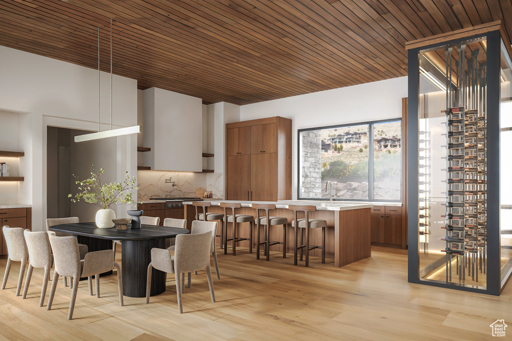 Dining space with wooden ceiling and light wood-type flooring