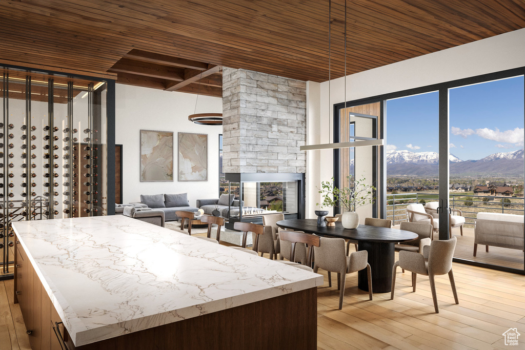 Kitchen with wood ceiling with exposed beams, a mountain view, and light wood finished floors