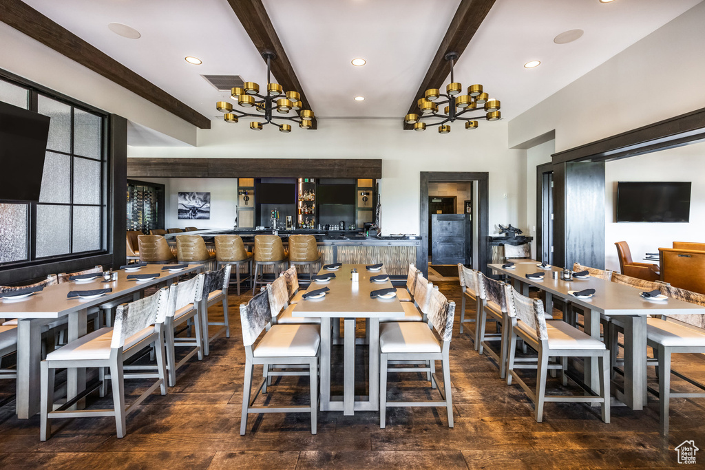 Dining room with beamed ceiling, a chandelier, hardwood / wood-style floors, and recessed lighting