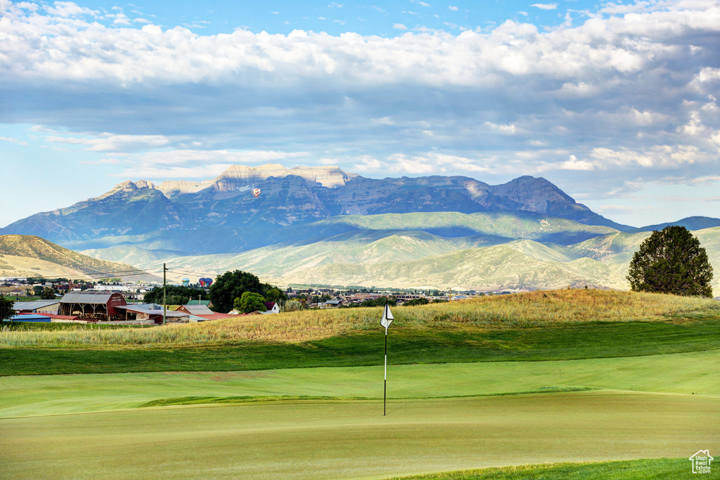 View of community with a mountain view, golf course view, and a putting green