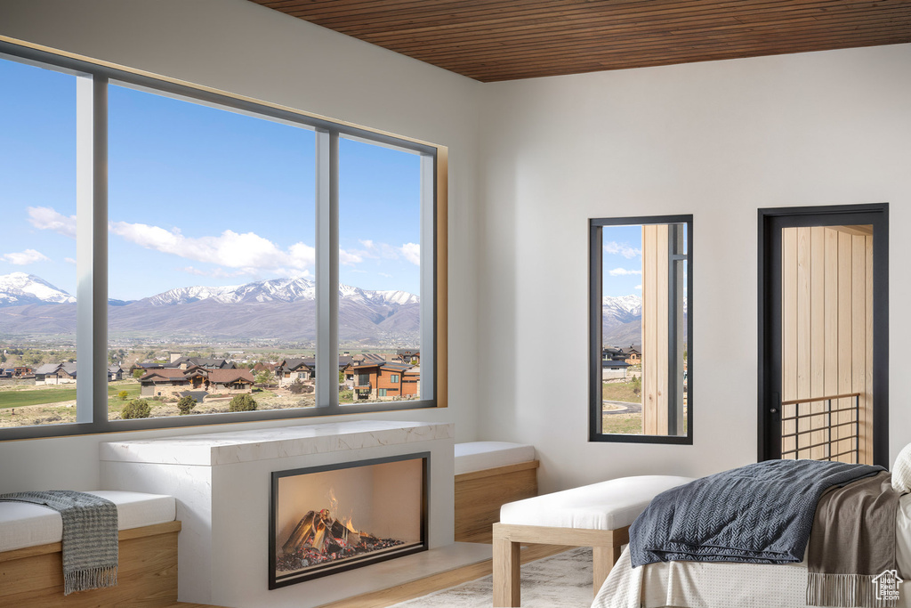 Bedroom featuring wooden ceiling and a mountain view