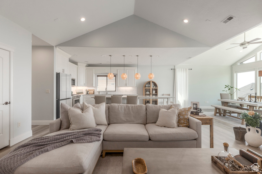 Living area featuring visible vents, high vaulted ceiling, ceiling fan, and recessed lighting