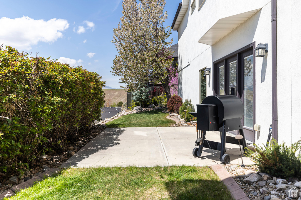 View of patio featuring fence
