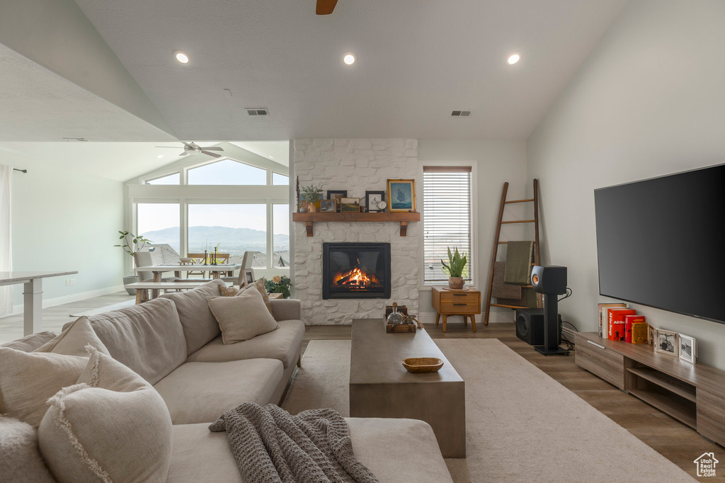 Living room with visible vents, wood finished floors, and ceiling fan