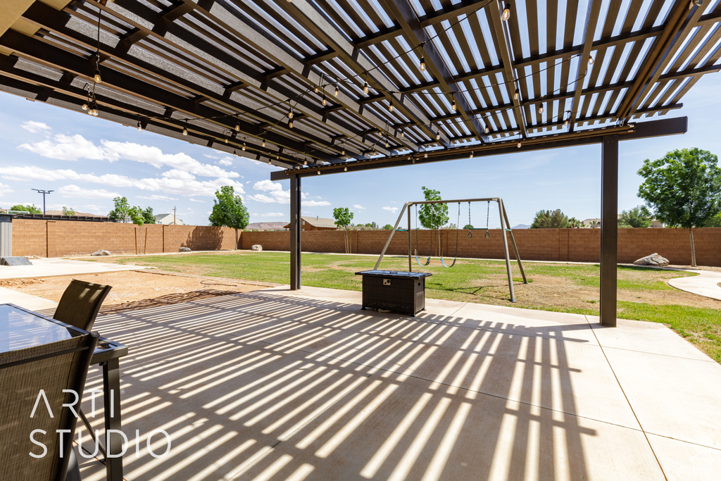 View of patio / terrace with a pergola, a playground, and a fenced backyard