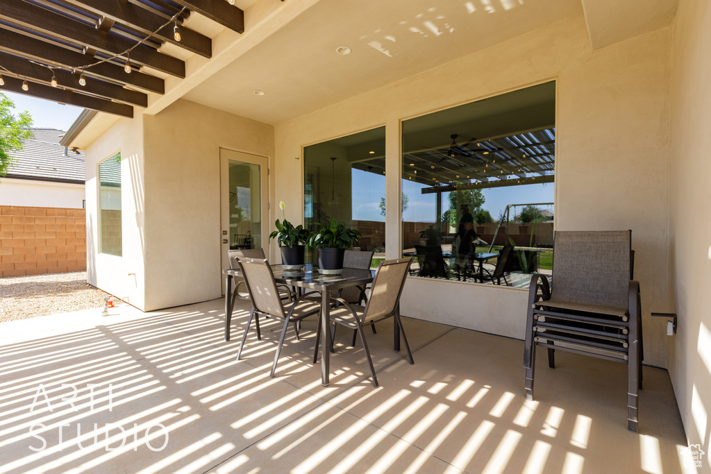 View of patio with outdoor dining area and fence