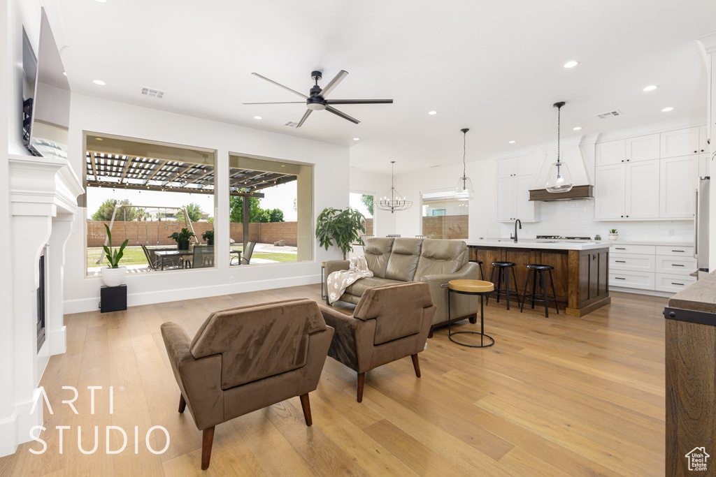 Living area featuring recessed lighting, a ceiling fan, visible vents, and light wood-style floors