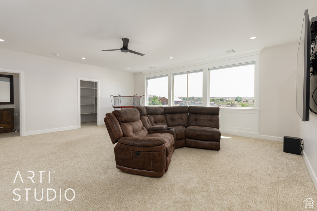 Carpeted living room featuring recessed lighting, ceiling fan, and baseboards