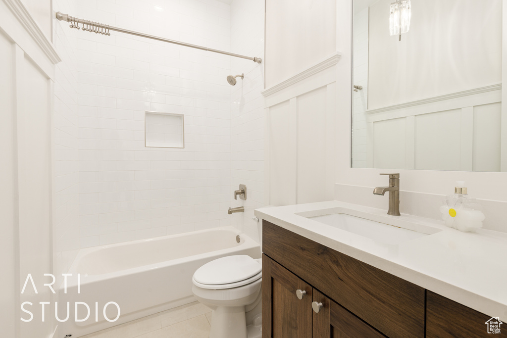 Bathroom with tile patterned floors, vanity, toilet, and tub / shower combination