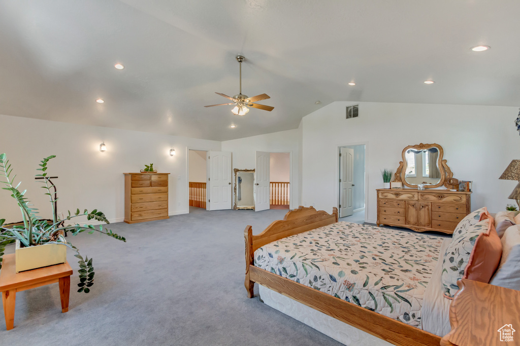 Carpeted bedroom featuring recessed lighting, ceiling fan, visible vents, baseboards, and lofted ceiling