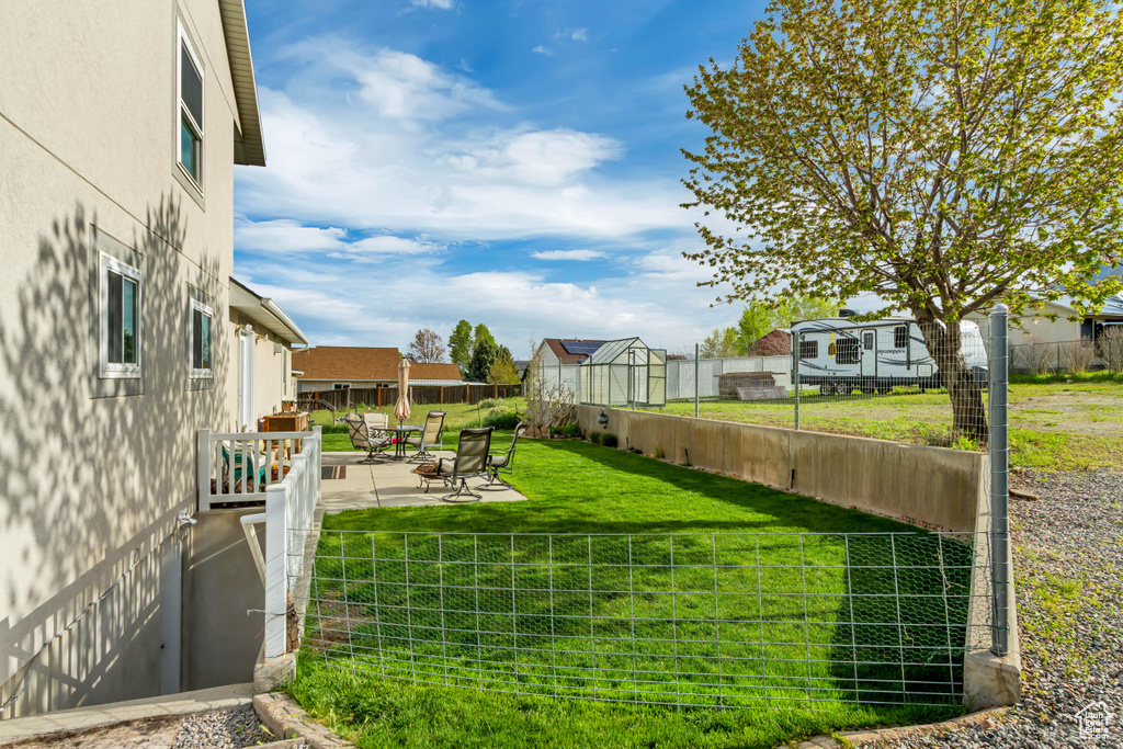 View of yard with a residential view, a fenced backyard, and a patio area