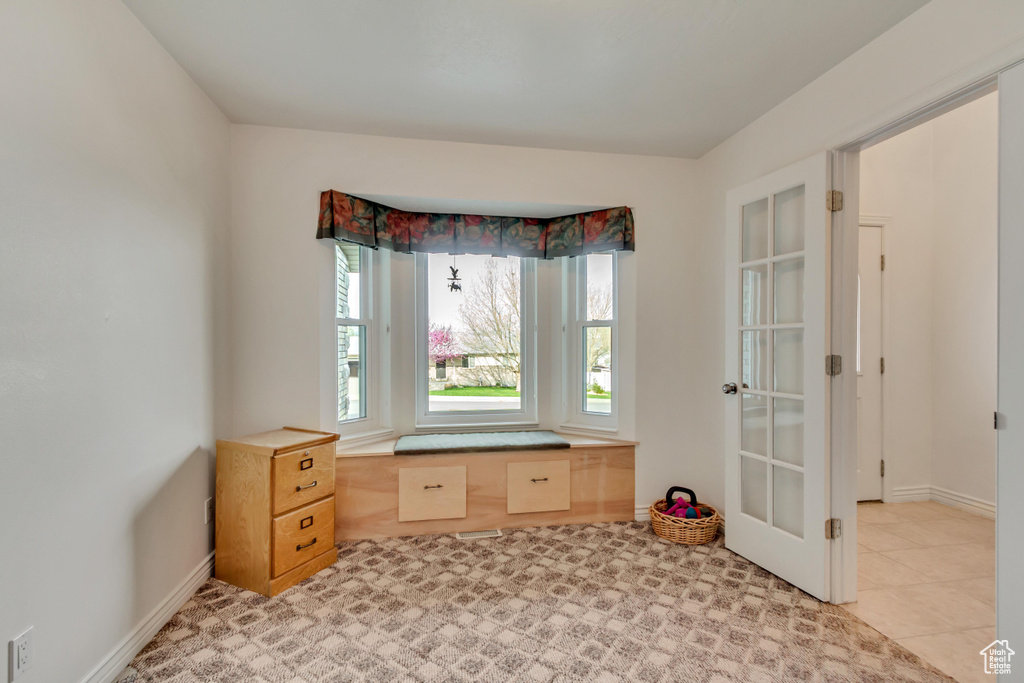 Spare room featuring french doors and baseboards