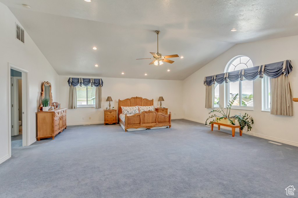 Carpeted bedroom with baseboards, visible vents, recessed lighting, and vaulted ceiling