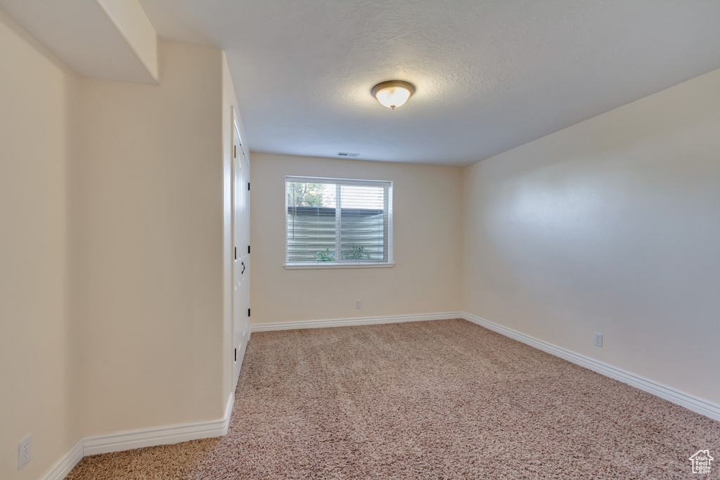 Unfurnished room featuring baseboards and carpet floors
