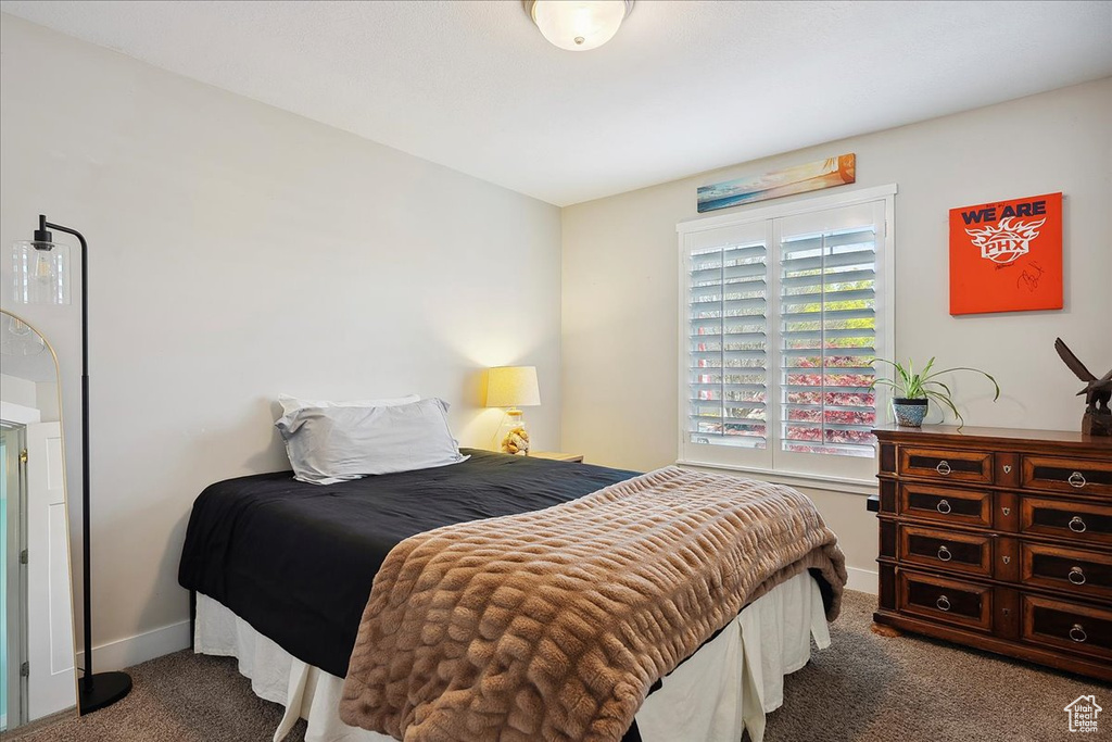Carpeted bedroom featuring baseboards