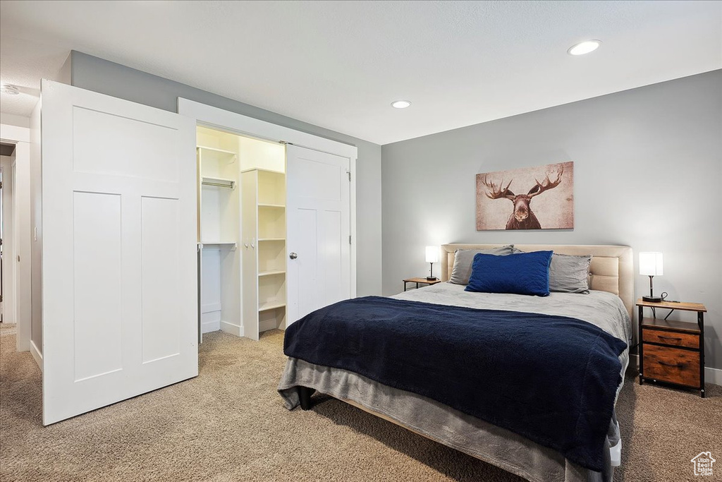 Bedroom featuring recessed lighting, light colored carpet, and baseboards