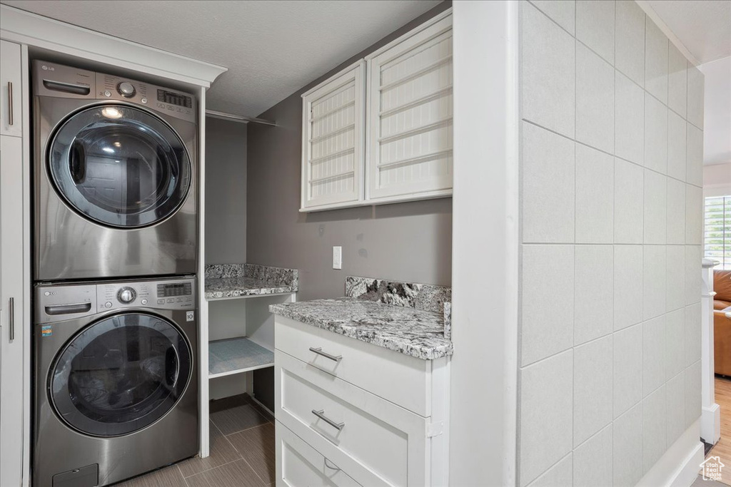 Washroom featuring stacked washer and clothes dryer
