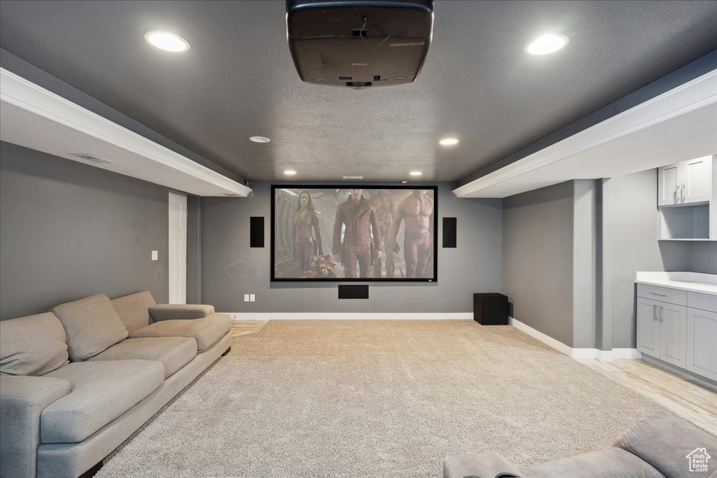 Cinema room with baseboards, recessed lighting, and light carpet