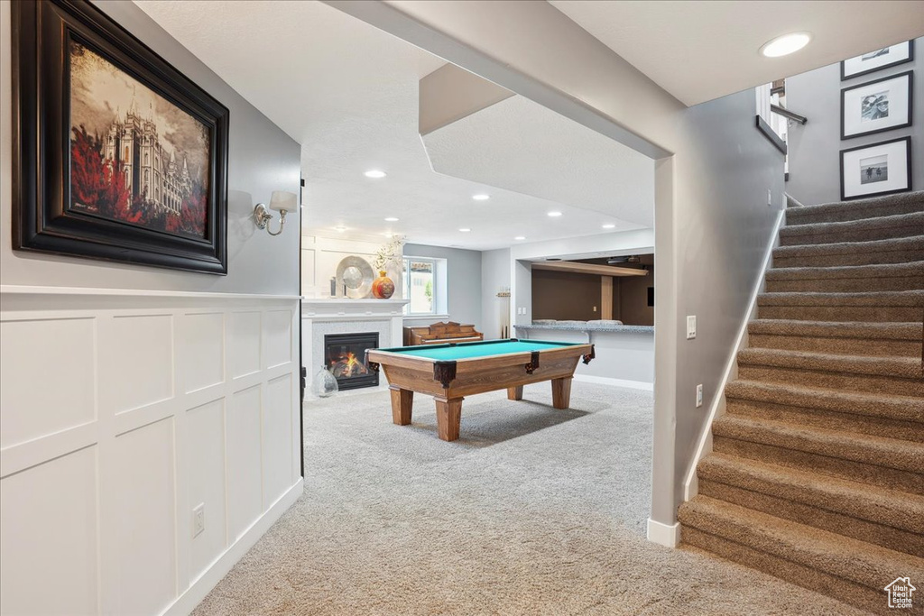 Rec room with a glass covered fireplace, recessed lighting, pool table, carpet, and wainscoting