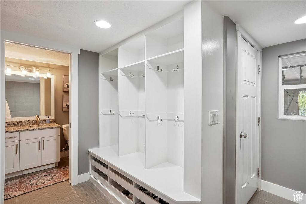 Mudroom with a sink, recessed lighting, and baseboards