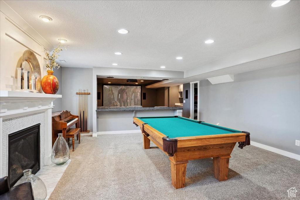 Recreation room with recessed lighting, carpet flooring, a tiled fireplace, billiards, and baseboards