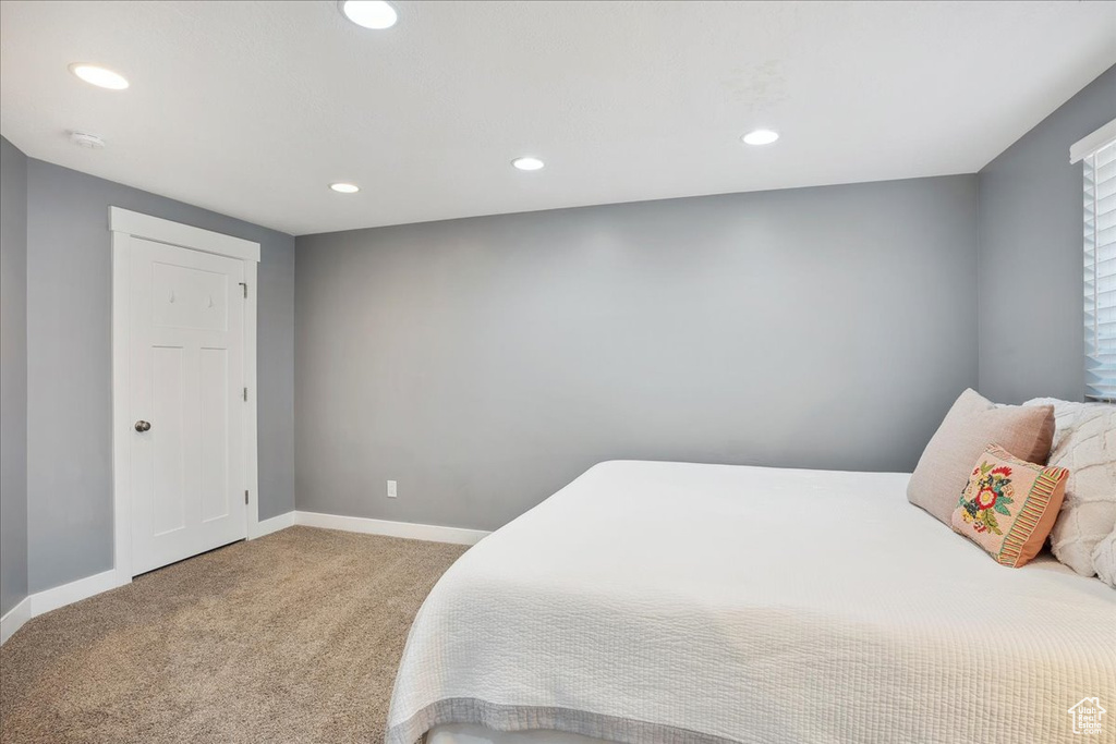 Bedroom featuring baseboards, recessed lighting, and carpet