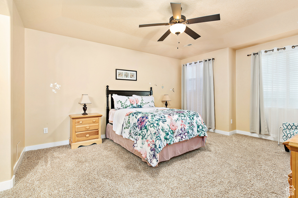 Bedroom featuring carpet, ceiling fan, and baseboards