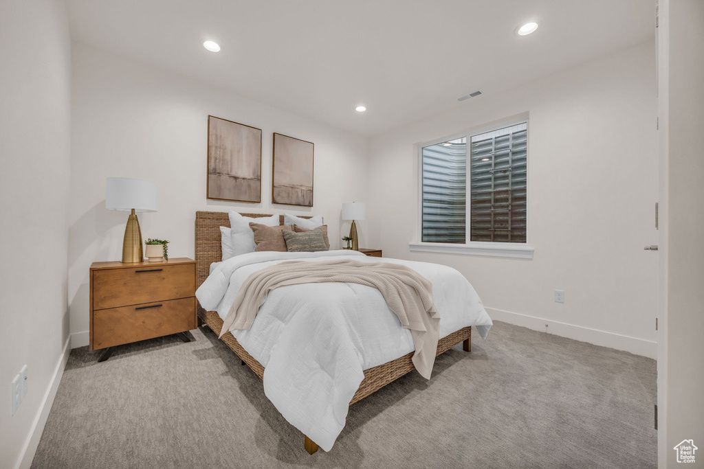 Bedroom featuring baseboards, light carpet, recessed lighting, and visible vents