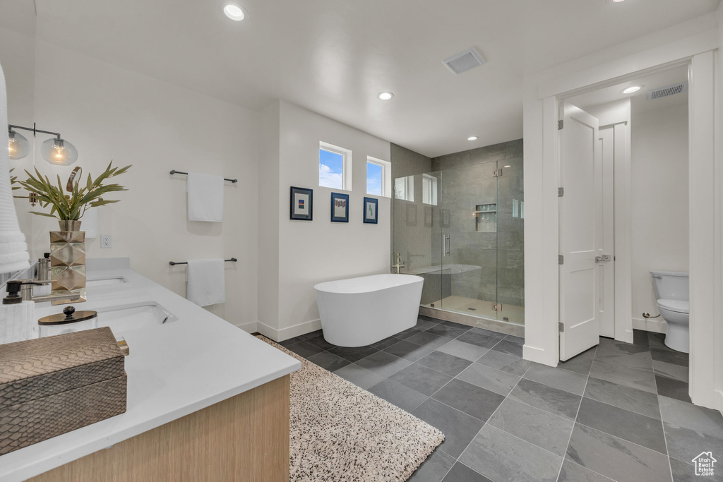 Bathroom with toilet, baseboards, recessed lighting, and a stall shower