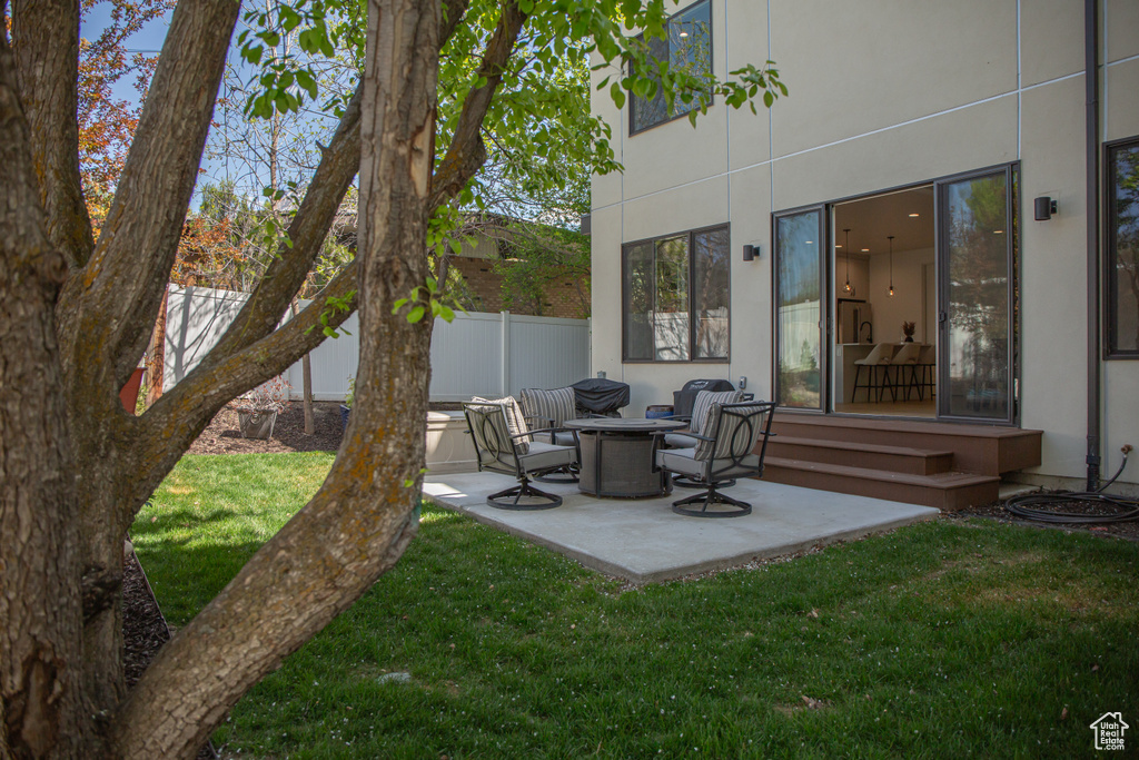 View of yard with fence and a patio area
