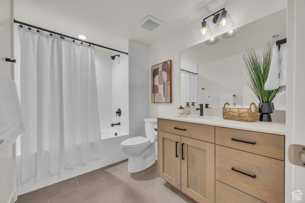 Bathroom featuring shower / bath combo, tile patterned flooring, vanity, toilet, and visible vents
