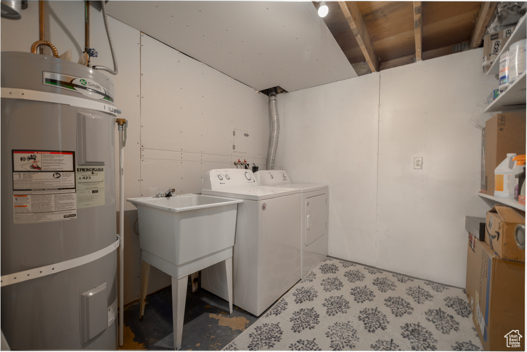 Washroom with laundry area, washer and clothes dryer, and water heater