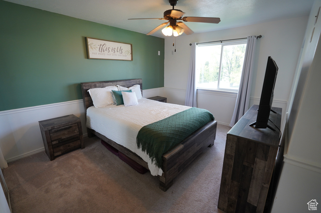 Bedroom with ceiling fan, carpet, and baseboards