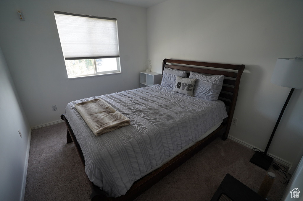 Carpeted bedroom featuring baseboards