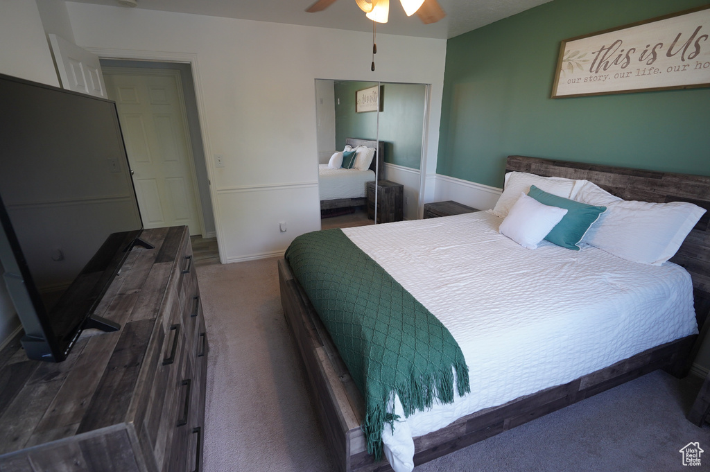 Bedroom featuring a ceiling fan, a closet, carpet, and baseboards
