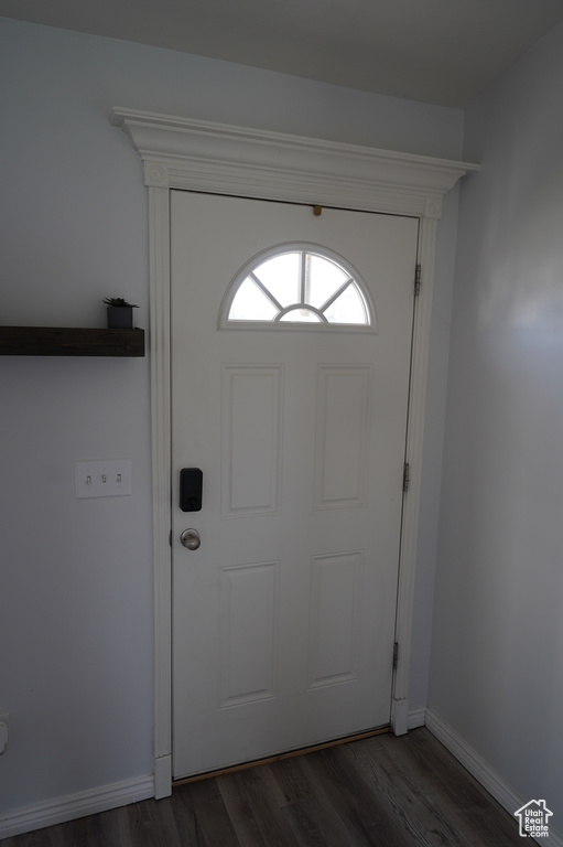 Foyer entrance with baseboards and dark wood-style flooring