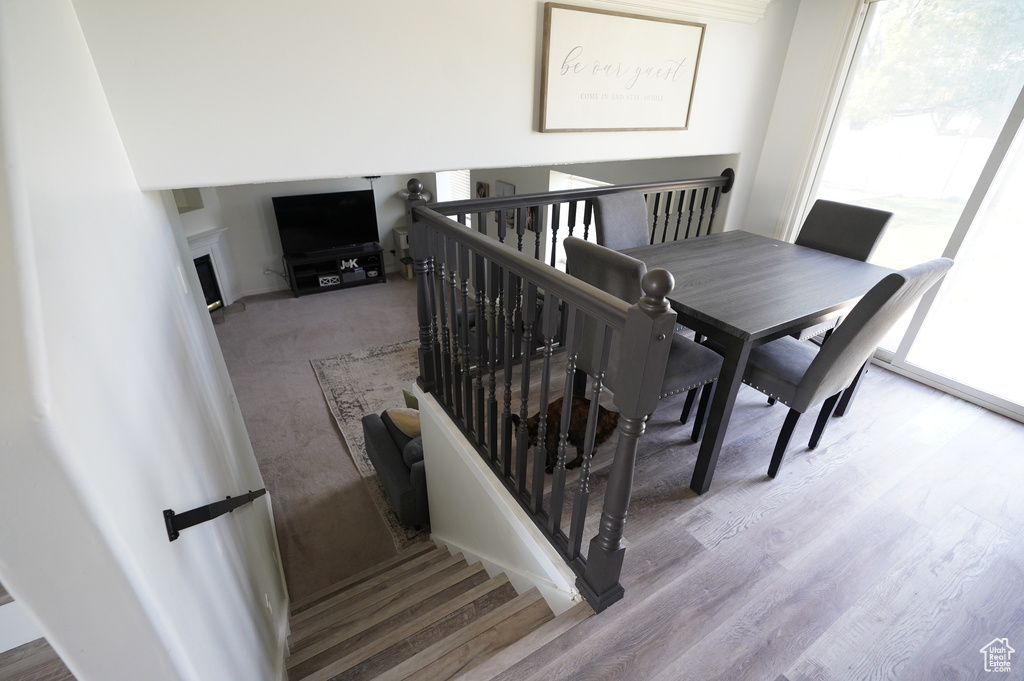 Dining area featuring wood finished floors and a fireplace