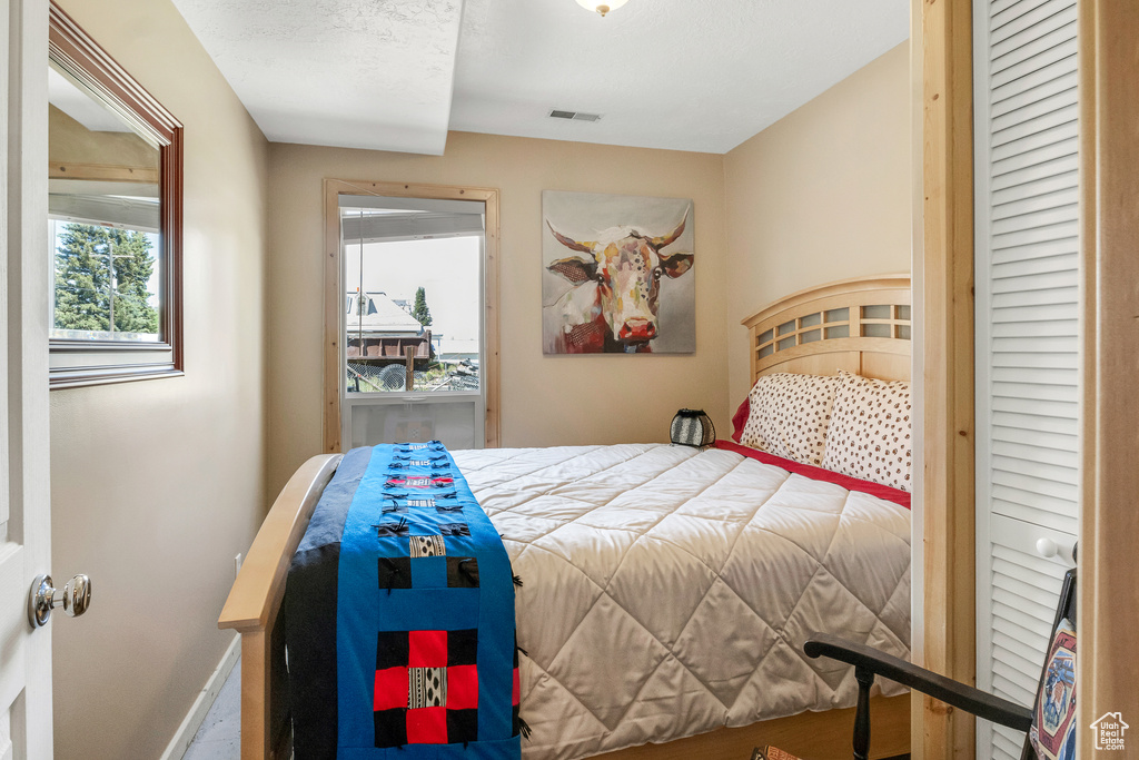 Bedroom with visible vents and baseboards