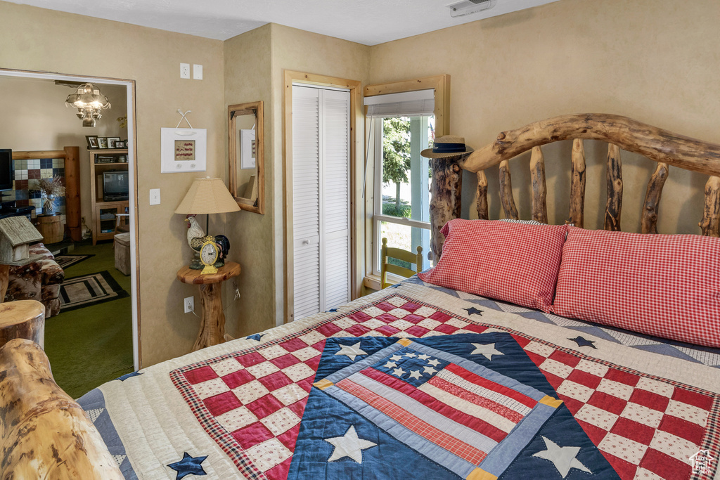 Carpeted bedroom with a closet