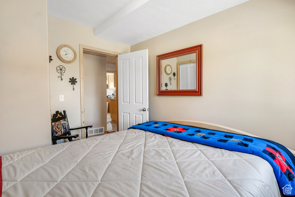 Bedroom with baseboards and visible vents