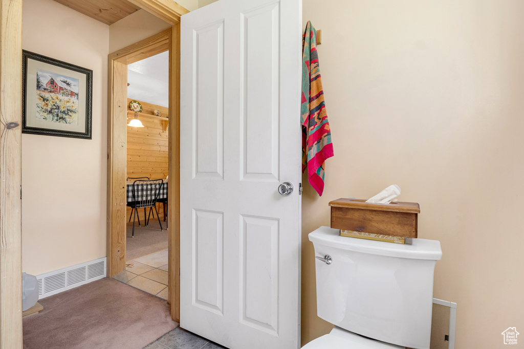 Bathroom with visible vents, toilet, and tile patterned flooring