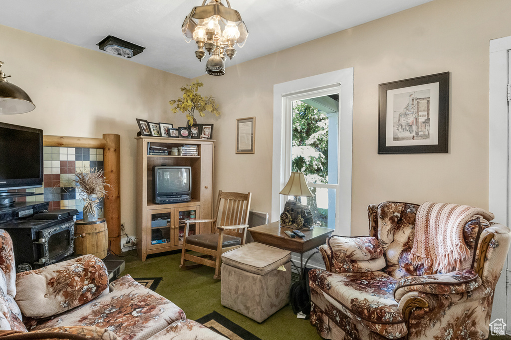 Living area with a chandelier and carpet floors