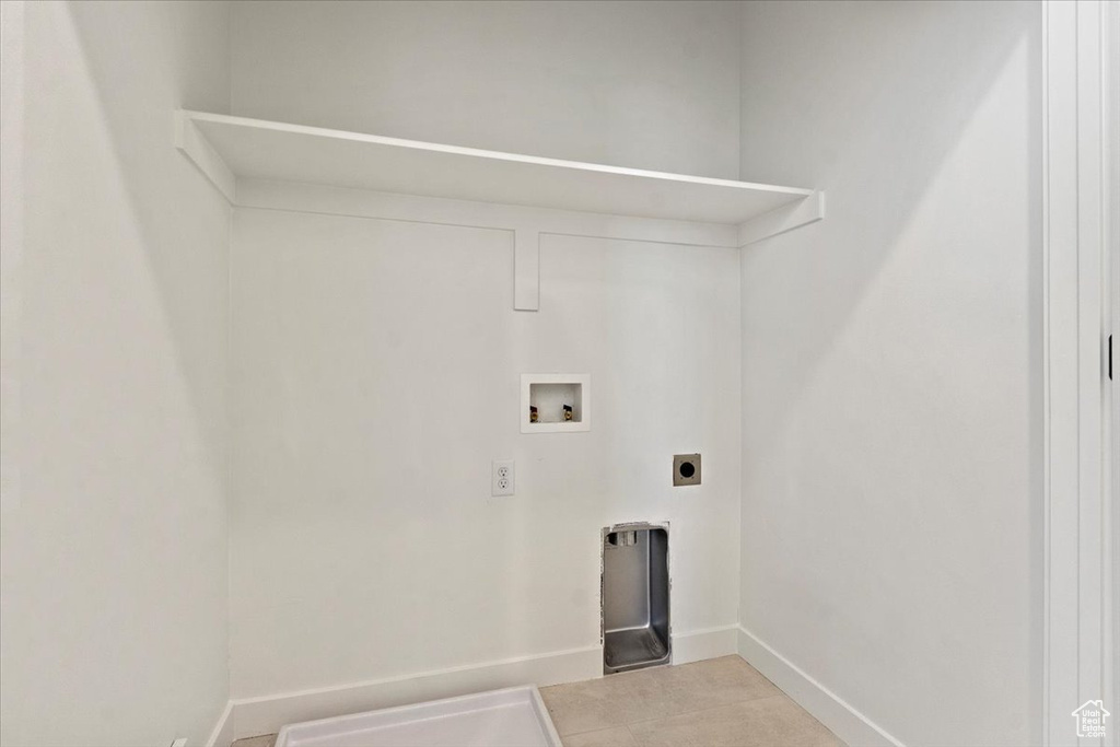 Laundry room featuring baseboards, electric dryer hookup, laundry area, and washer hookup