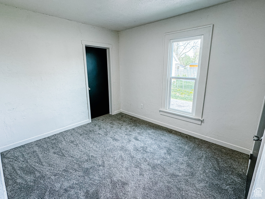 Carpeted spare room with baseboards