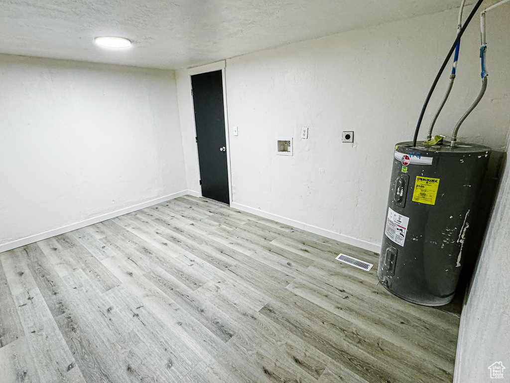 Interior space featuring visible vents and water heater