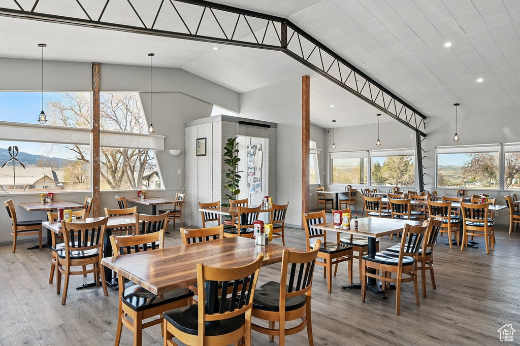 Dining space featuring recessed lighting, wood finished floors, and high vaulted ceiling