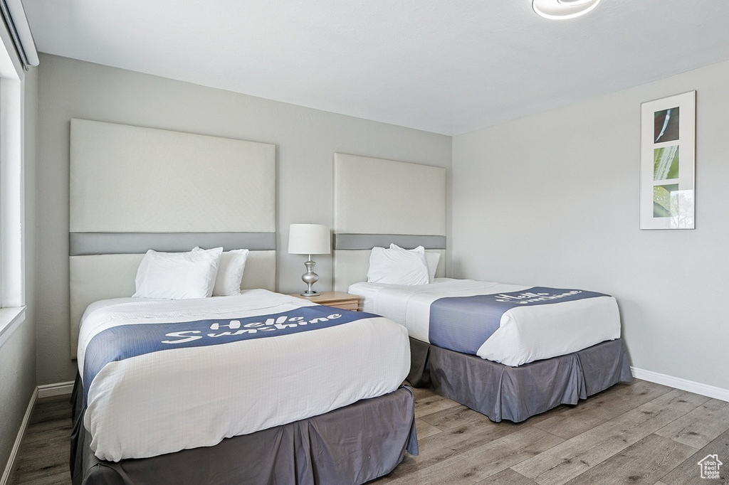 Bedroom with baseboards and wood finished floors
