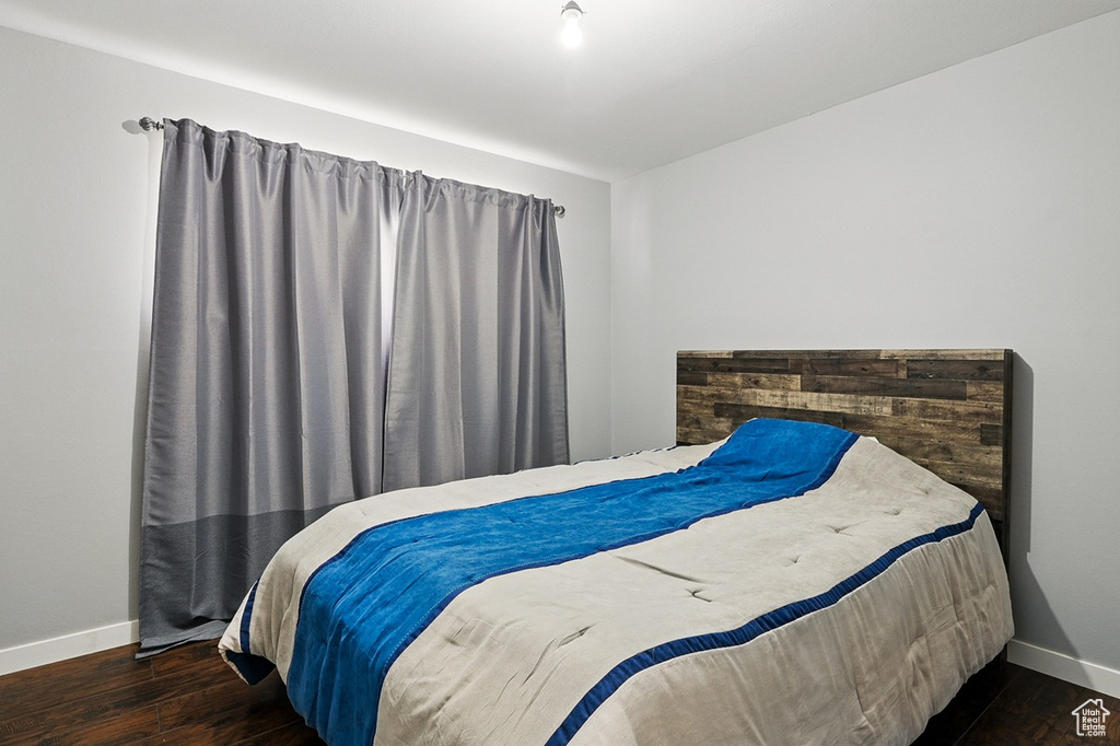 Bedroom featuring wood finished floors and baseboards